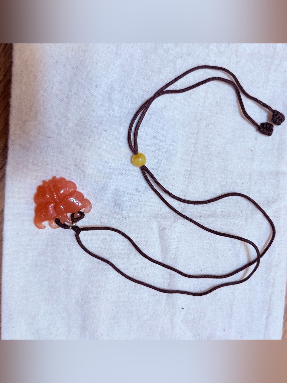 Orange Carved Pendant Necklace on Brown Cord